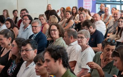 Die Gäste der Preisverleihung sitzen in einem Saal.